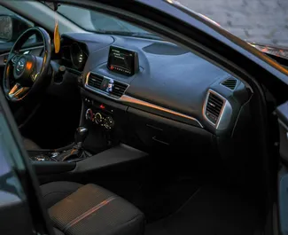Wnętrze Mazda 3 do wynajęcia w Gruzji. Doskonały samochód 5-osobowy. ✓ Skrzynia Automatyczna.