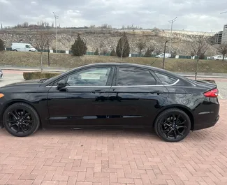 Wynajem samochodu Ford Fusion Sedan nr 15853 (Automatyczna) na lotnisku w Erewaniu, z silnikiem 2,5l. Benzyna ➤ Bezpośrednio od Nairi w Armenii.