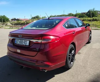 Wnętrze Ford Fusion Sedan do wynajęcia w Gruzji. Doskonały samochód 5-osobowy. ✓ Skrzynia Automatyczna.
